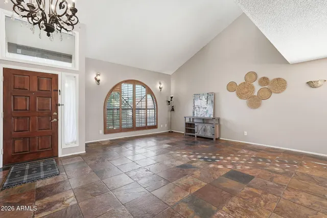 a view of a livingroom with wooden floor and entryway