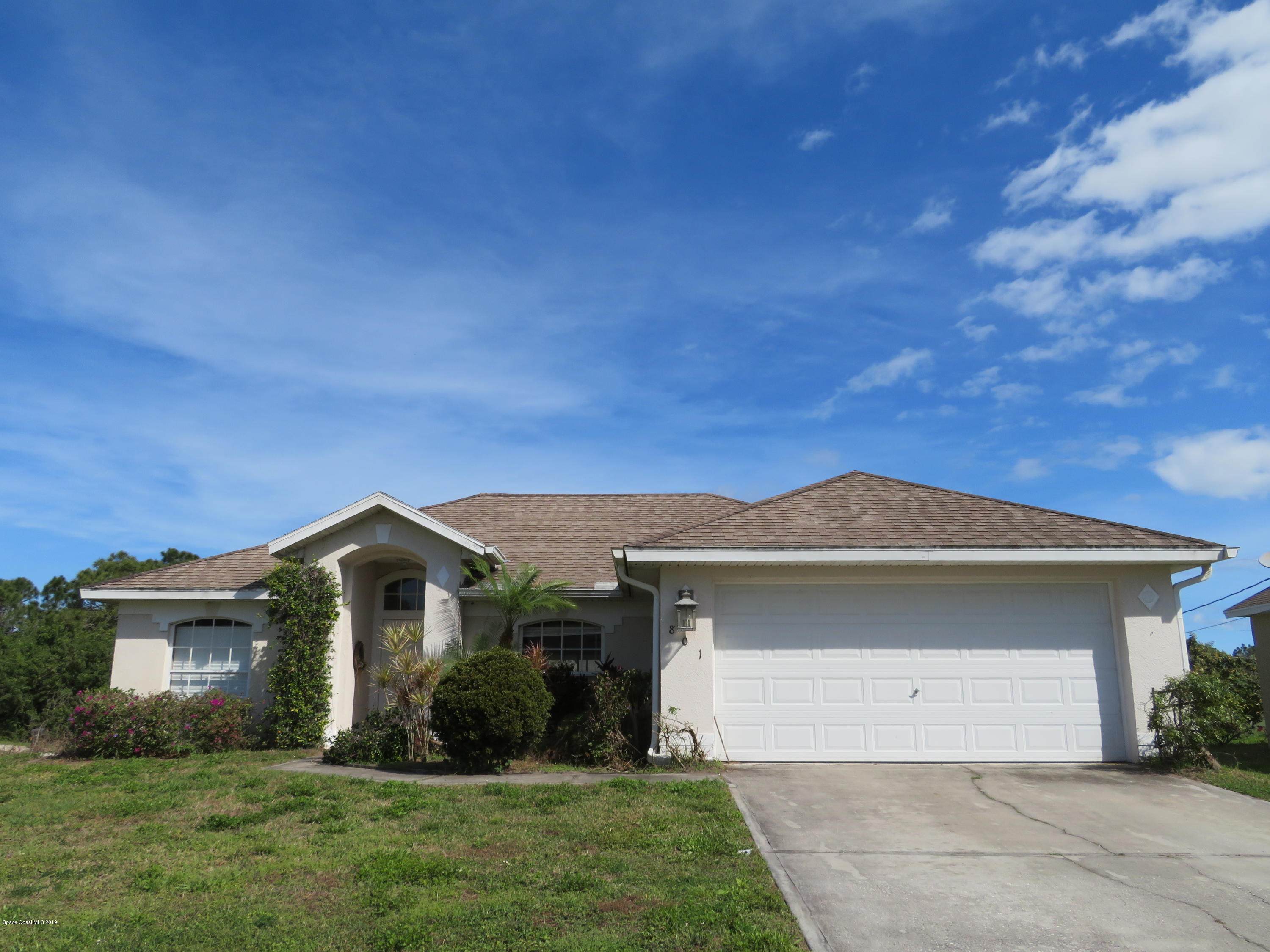 801 Clifton Road Southeast Palm Bay, FL 32909 - Photo 1 of 25 a front view of a house with a yard and garage