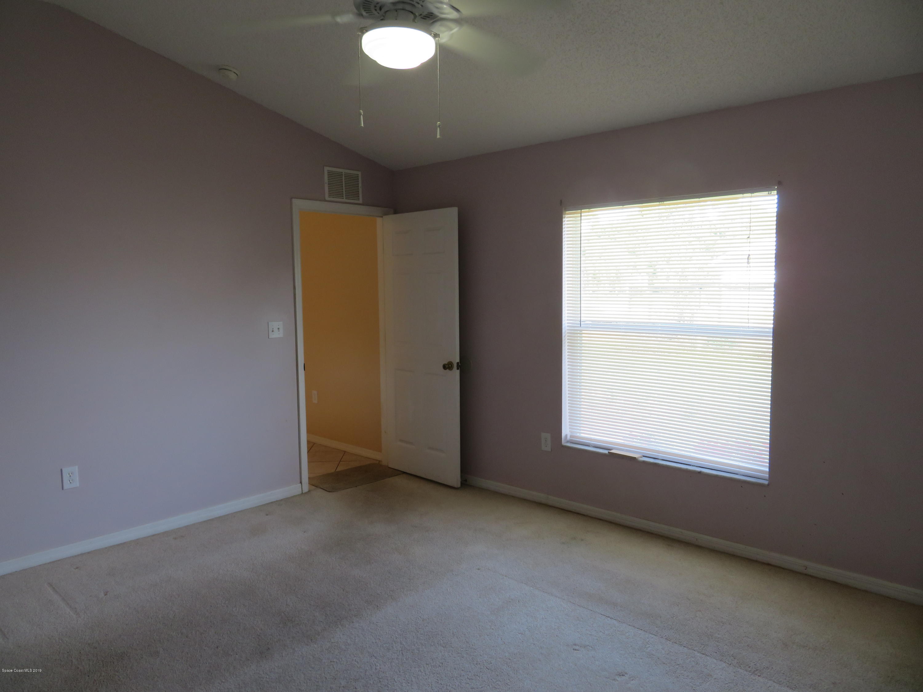 801 Clifton Road Southeast Palm Bay, FL 32909 - Photo 11 of 25 a view of an empty room with a window