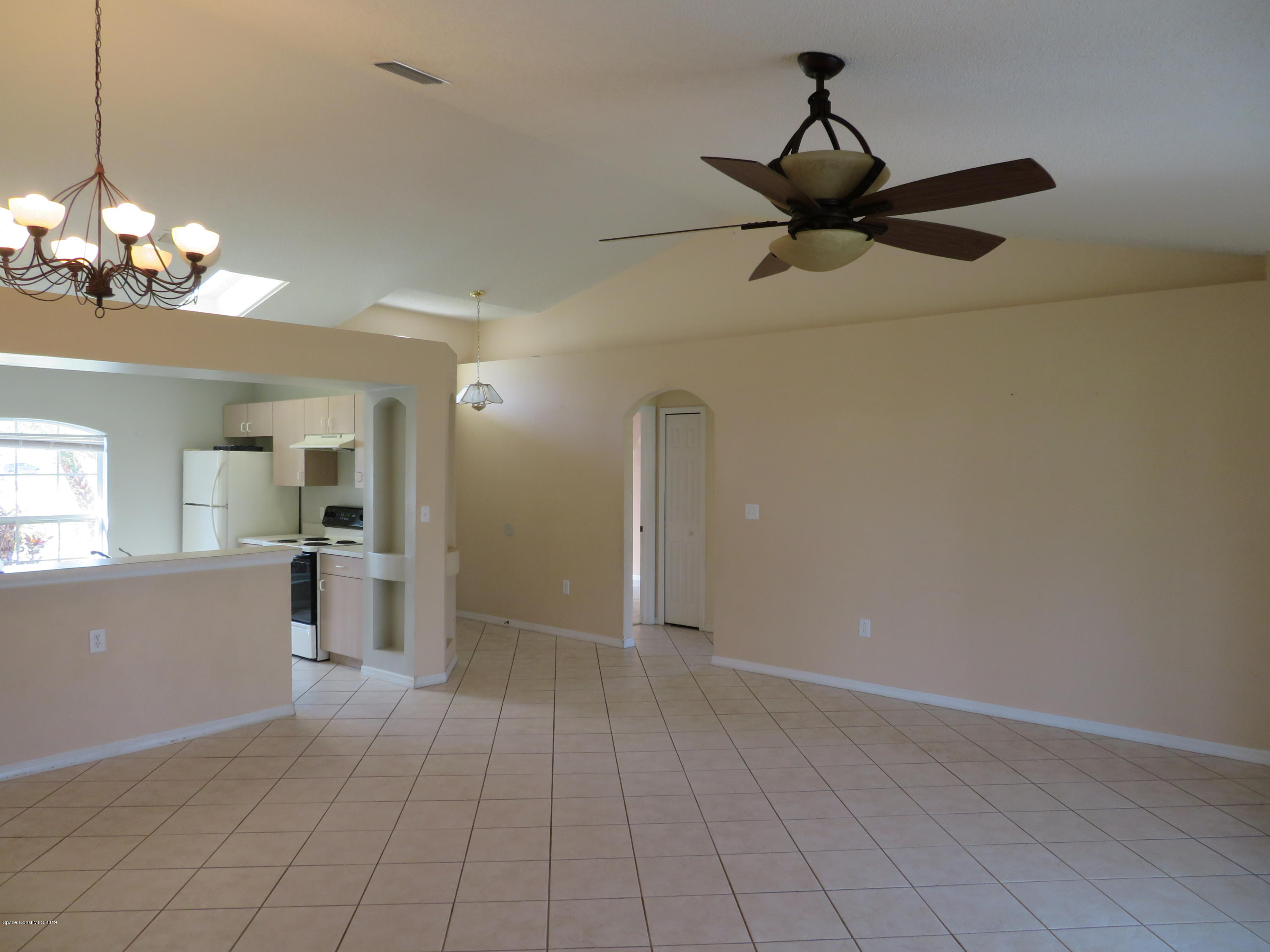 801 Clifton Road Southeast Palm Bay, FL 32909 - Photo 3 of 25 a view of a livingroom with a chandelier fan and windows