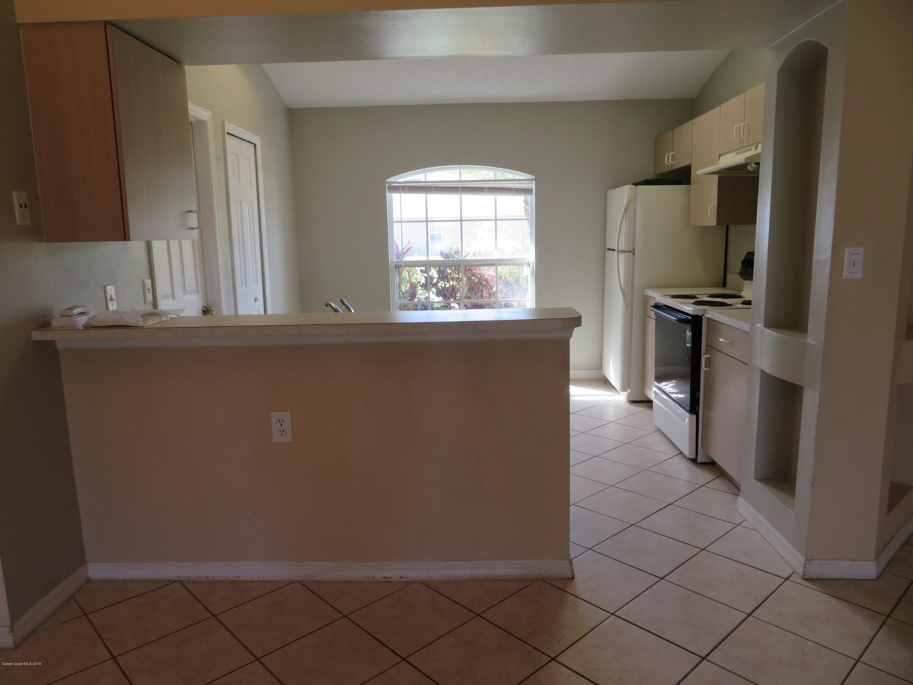 801 Clifton Road Southeast Palm Bay, FL 32909 - Photo 6 of 25 a kitchen with stainless steel appliances a refrigerator and a stove top oven