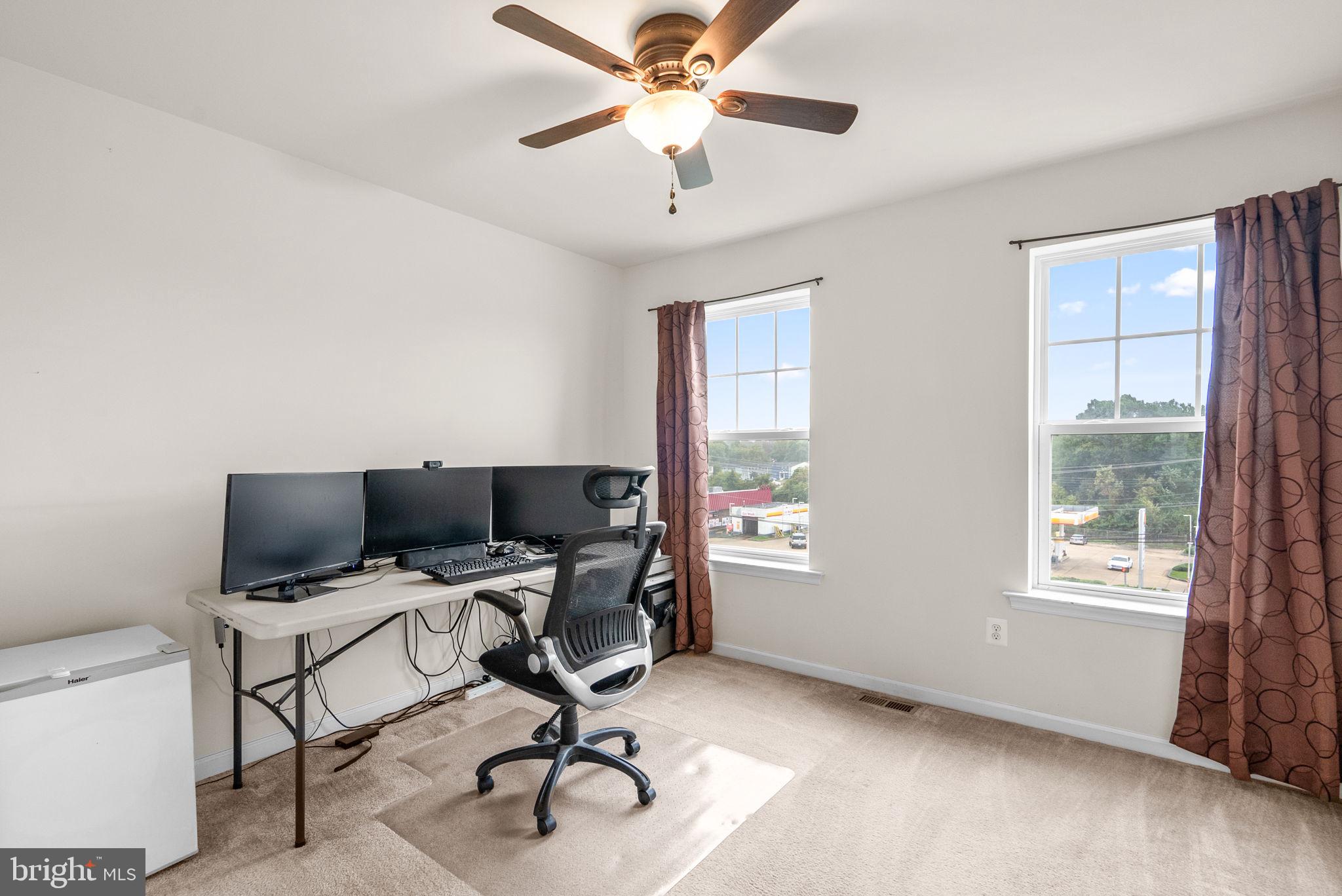 2701 Pinebrook Road Hyattsville, MD 20785 - Photo 22 of 27 a view of a workspace with furniture and a window