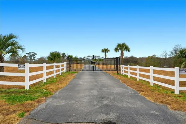 a view of a yard with wooden fence