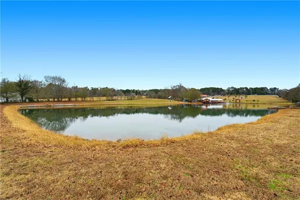 a view of a lake with houses in the background