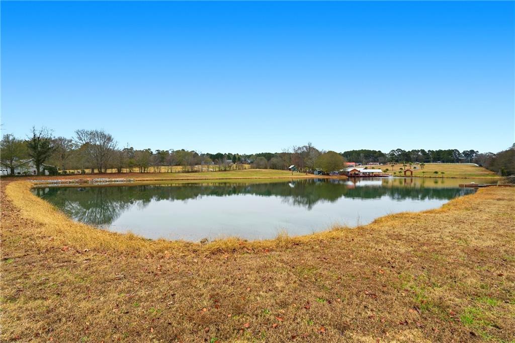 1188 Carl-Bethlehem Road Winder, GA 30680 - Photo 28 of 31 a view of a lake with houses in the background