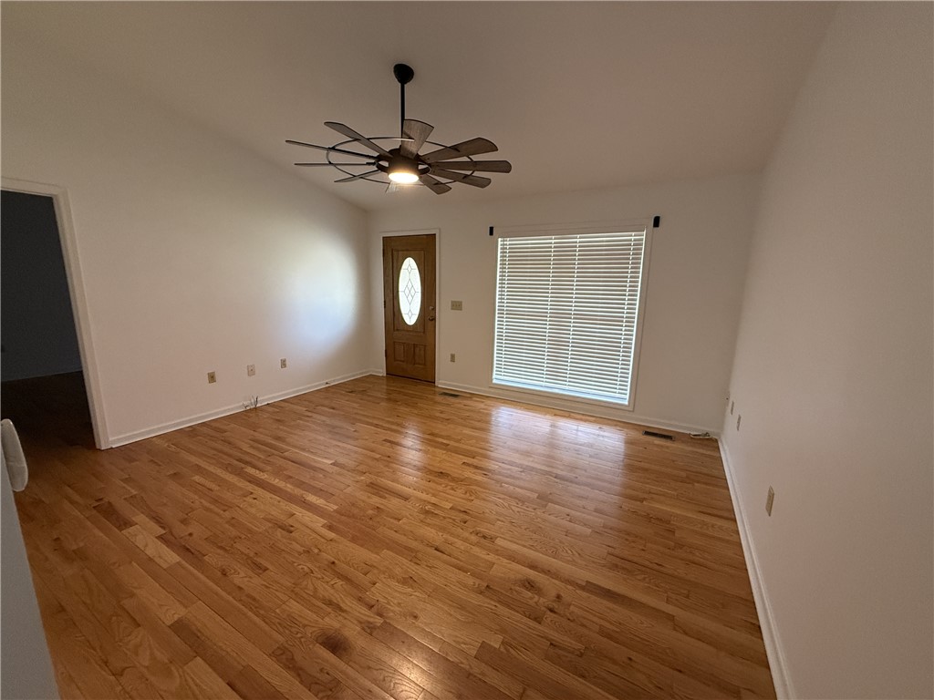 311 Dixie Drive Seneca, SC 29672 - Photo 2 of 8 This bright room features beautiful wood flooring and a modern ceiling fan, creating an inviting atmosphere.