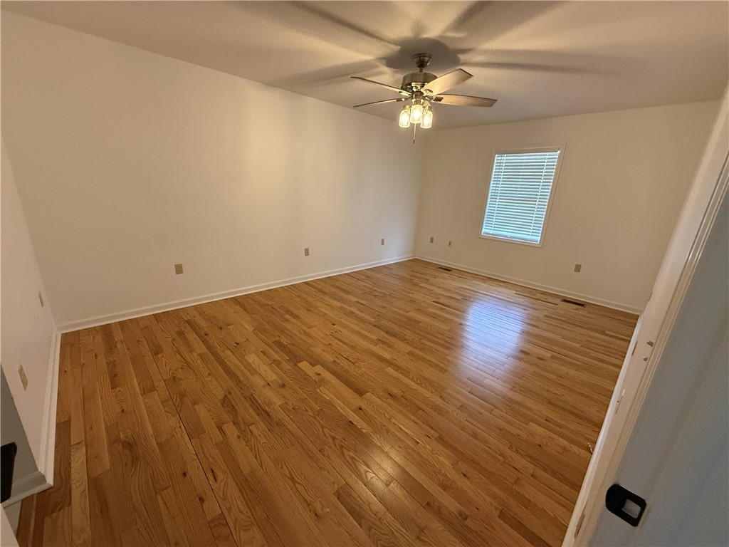 311 Dixie Drive Seneca, SC 29672 - Photo 3 of 8 This spacious room features abundant natural light and warm hardwood flooring.