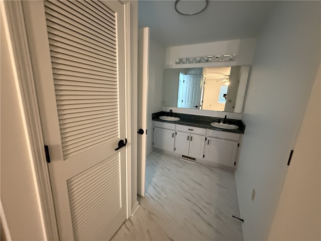311 Dixie Drive Seneca, SC 29672 - Photo 7 of 8 This spacious bathroom offers dual vanities and modern flooring for everyday convenience.