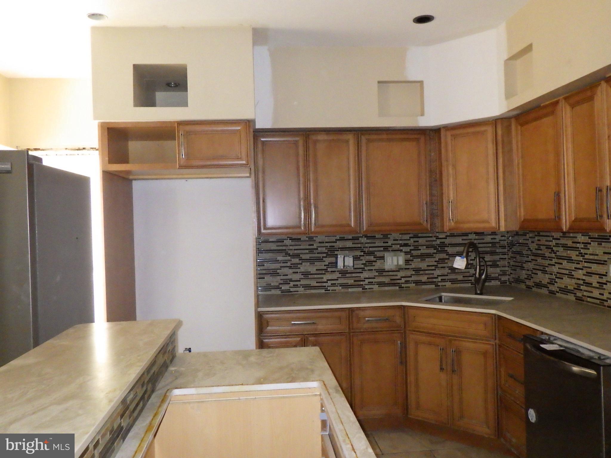 260 Harvey Street Philadelphia, PA 19144 - Photo 8 of 25 a kitchen with granite countertop a sink and a stove