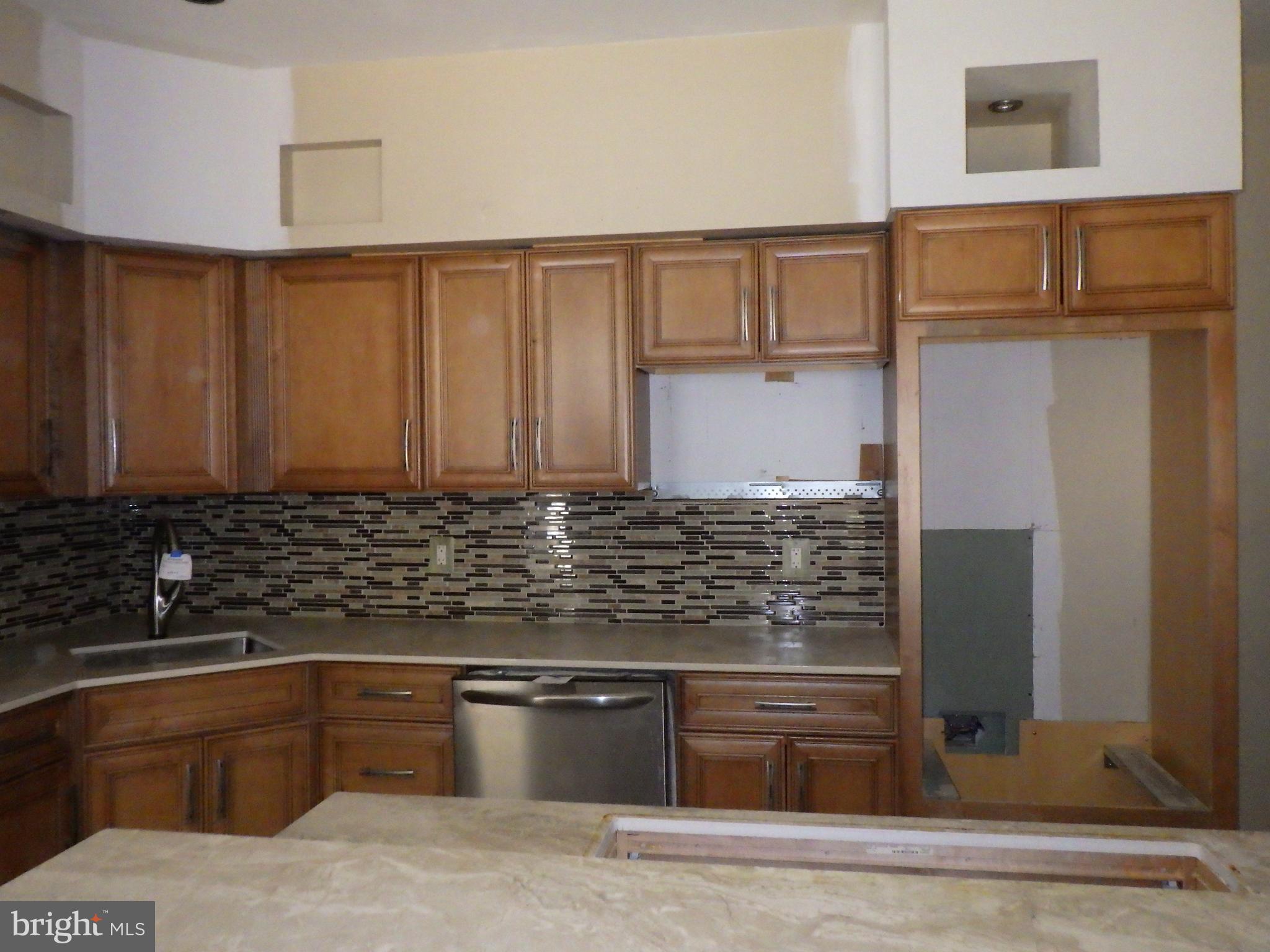 260 Harvey Street Philadelphia, PA 19144 - Photo 9 of 25 a kitchen with granite countertop a sink and a stove