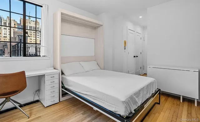 a bedroom with a bed and a chair