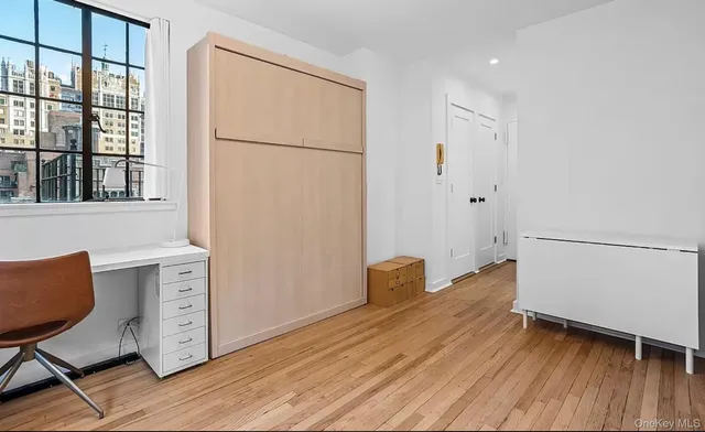 a view of cabinets with wooden floor and windows