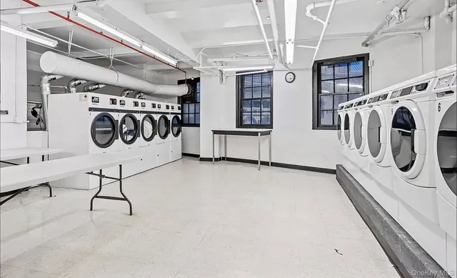 a utility room with multiple dryer and washer