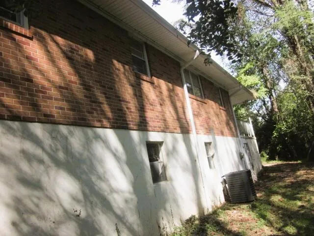 a bathroom with a sink toilet and window
