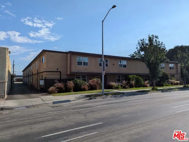 a street sign on a sidewalk next to a road