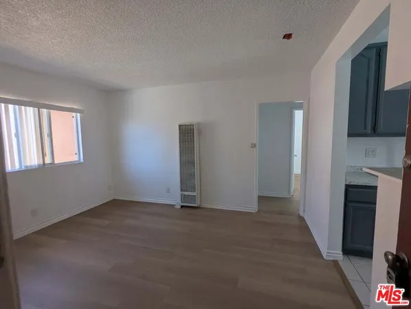a view of an empty room with window and fire place