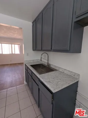 a kitchen with a sink a microwave and cabinets