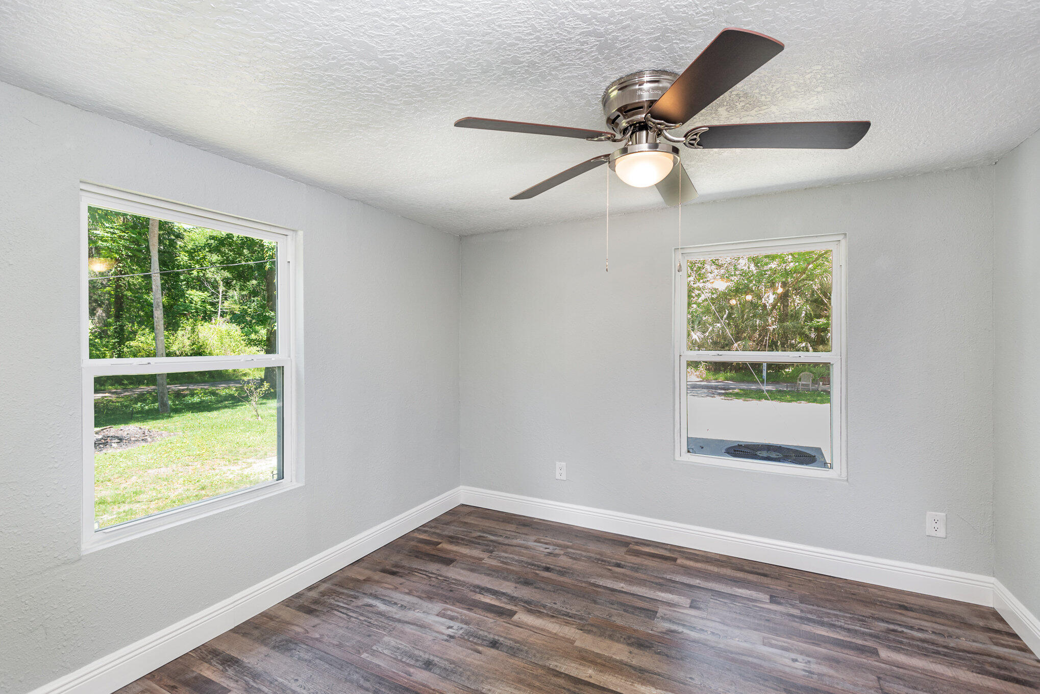 24050 Bass Road Astor, FL 32102 - Photo 15 of 22 a view of an empty room with wooden floor and a window