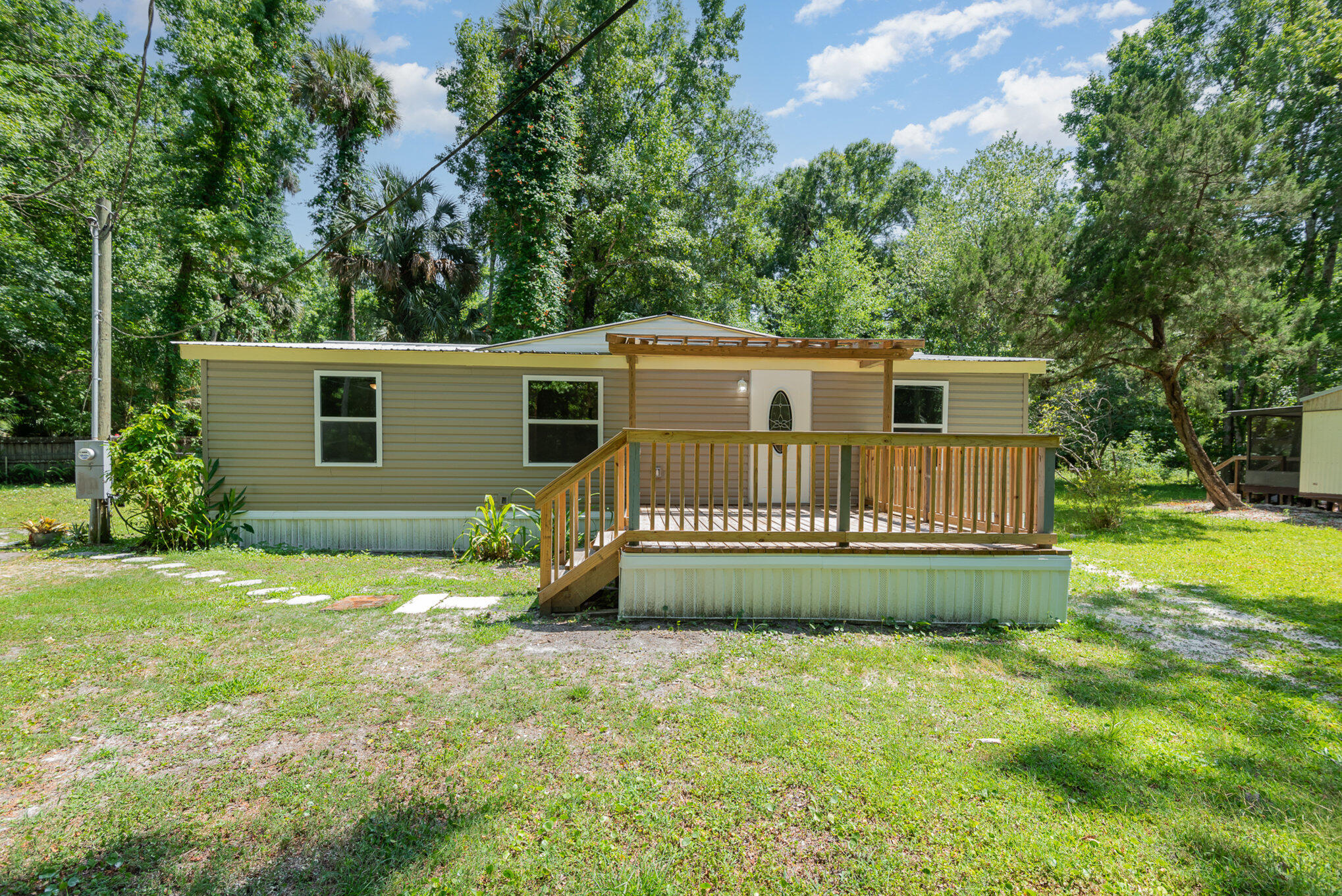 24050 Bass Road Astor, FL 32102 - Photo 22 of 22 a view of a house with a yard and deck