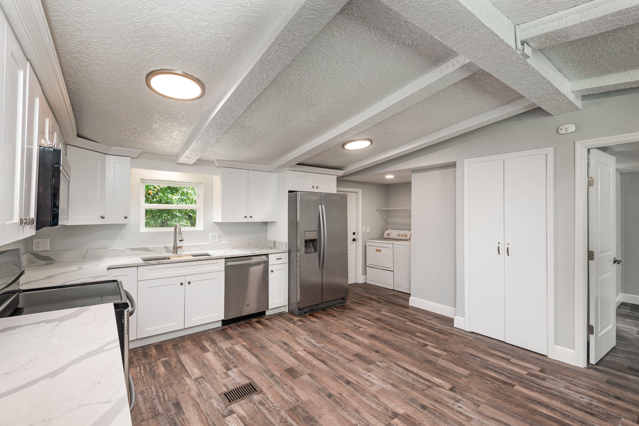 24050 Bass Road Astor, FL 32102 - Photo 6 of 22 a kitchen with a sink dishwasher stove and refrigerator