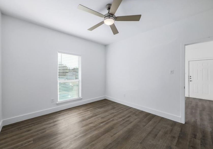 114 East 31st Street, Unit 314 Austin, TX 78705 - Photo 13 of 20 an empty room with wooden floor fan and windows