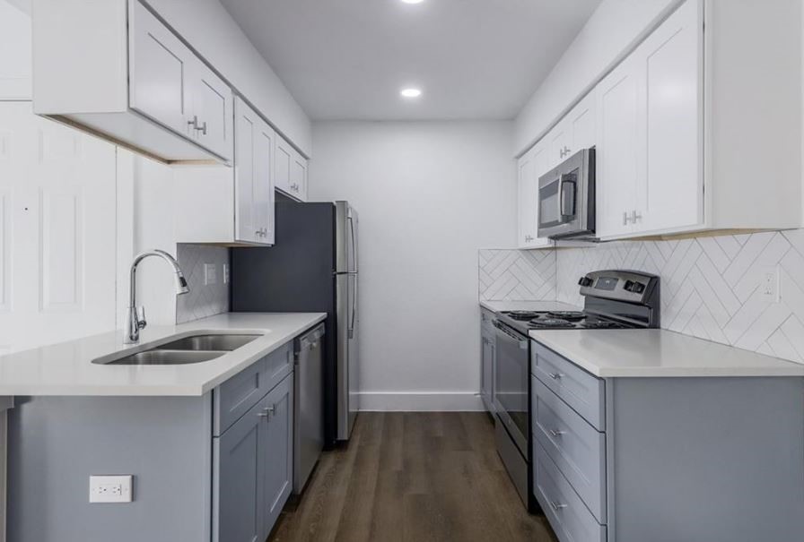114 East 31st Street, Unit 314 Austin, TX 78705 - Photo 7 of 20 a kitchen with stainless steel appliances granite countertop a sink stove and refrigerator