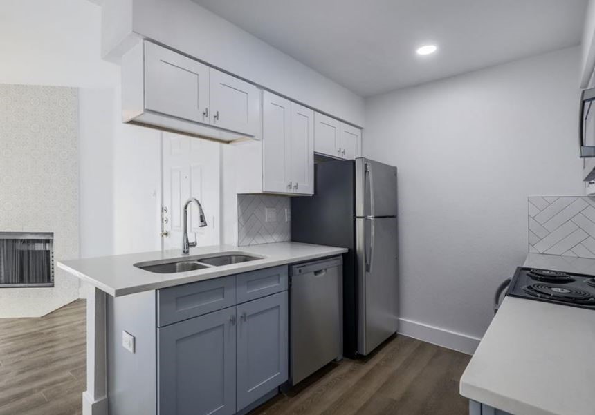 114 East 31st Street, Unit 314 Austin, TX 78705 - Photo 8 of 20 a kitchen with stainless steel appliances granite countertop a sink stove and refrigerator