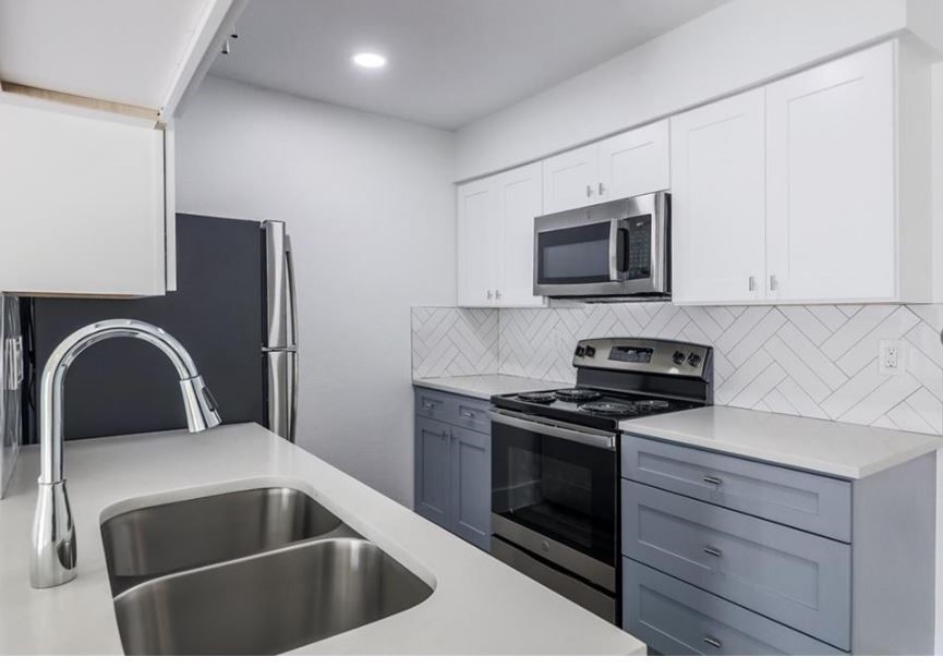 114 East 31st Street, Unit 314 Austin, TX 78705 - Photo 9 of 20 a kitchen with a stove and a microwave
