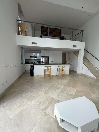 a living room with furniture and chairs