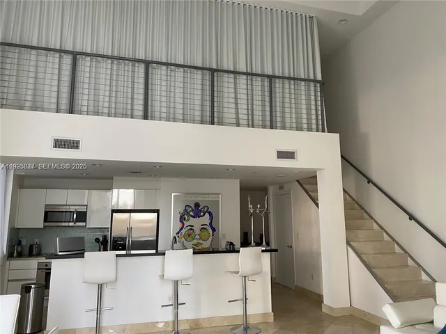 a view of living room kitchen with furniture and flat screen tv