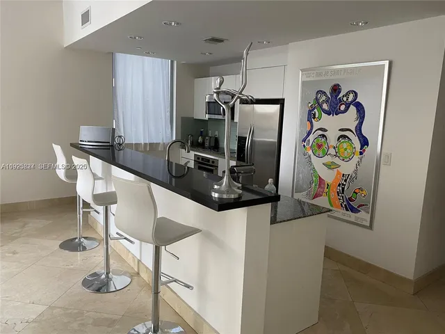 a kitchen with a refrigerator and a sink