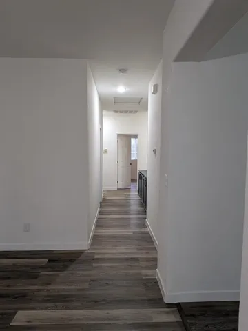 a view of front door with wooden floor
