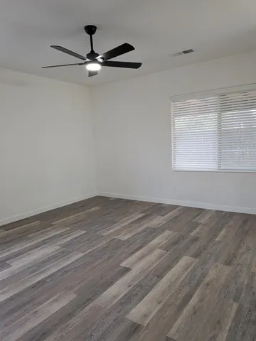 a bathroom with a granite countertop toilet and a sink