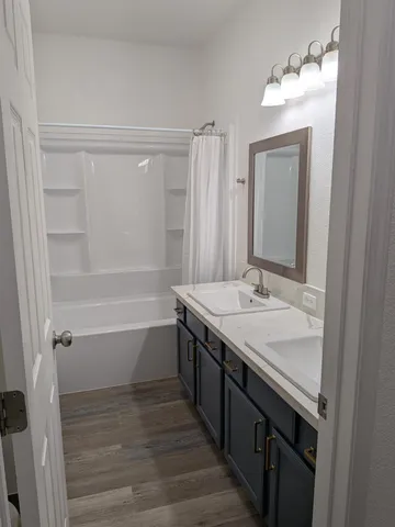 a bathroom with a bathtub and a shower