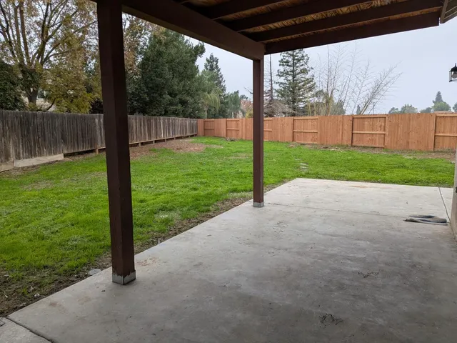 a view of a house with a yard and sitting area