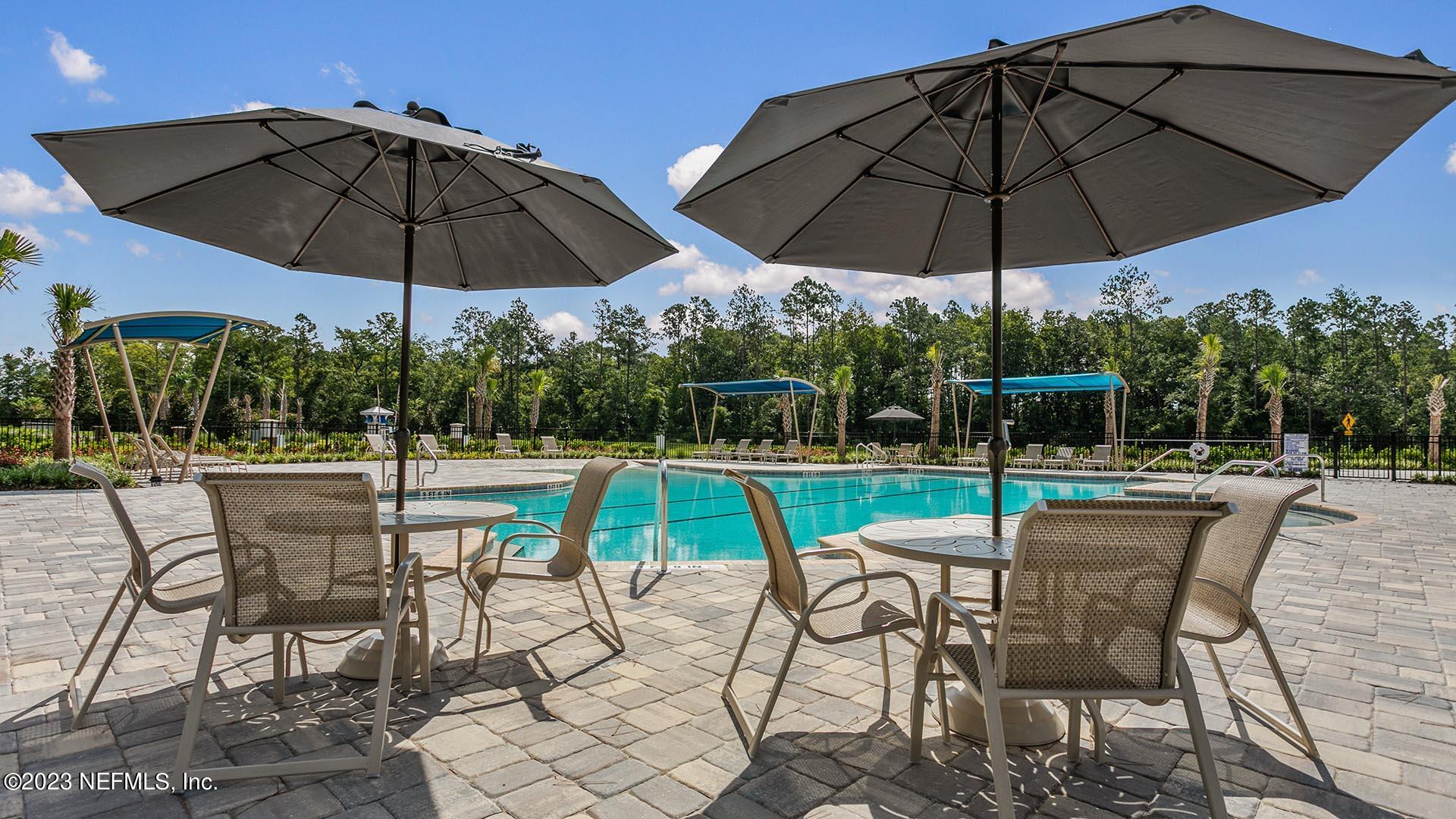 57 Java Lane St. Augustine, FL 32092 - Photo 26 of 37 a view of a table and chairs under an umbrella