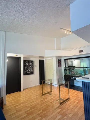 a view of a kitchen with kitchen island stainless steel appliances refrigerator stove microwave and cabinets