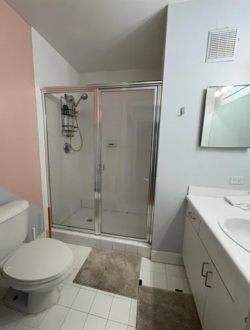 a bathroom with a shower a toilet and a sink