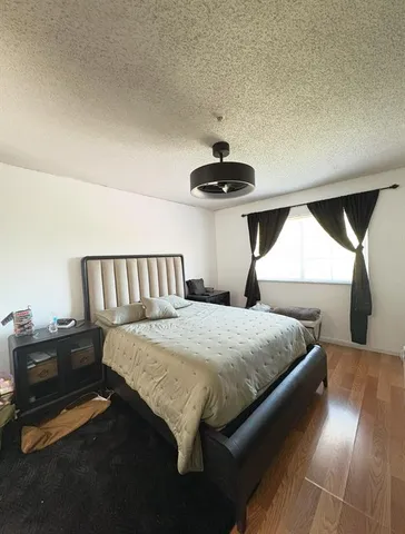 a bedroom with a bed and a chandelier