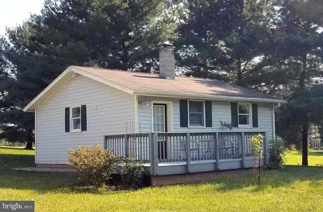 a view of a house with swimming pool next to a yard