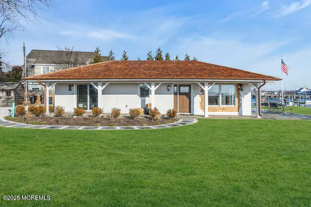 a front view of a house with a garden and patio