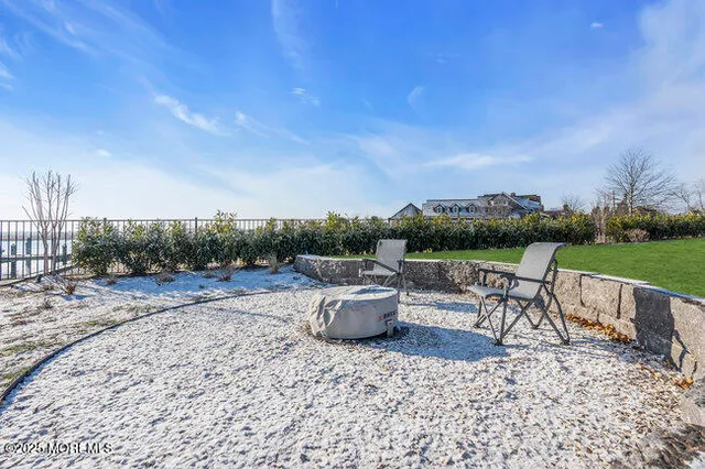 a view of a terrace with furniture and a garden