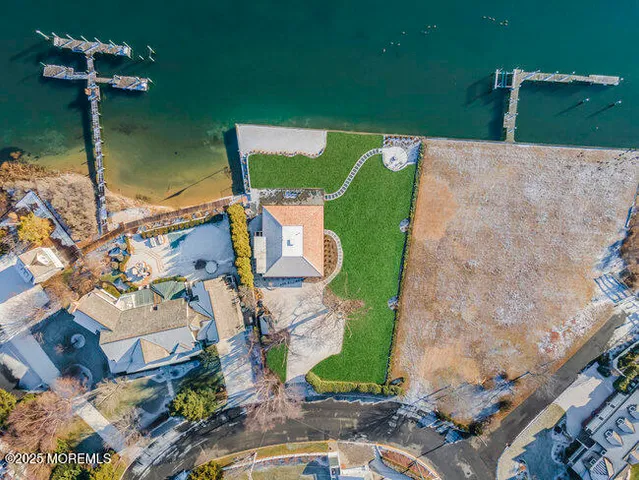 an aerial view of a house with a yard basket ball court and outdoor seating