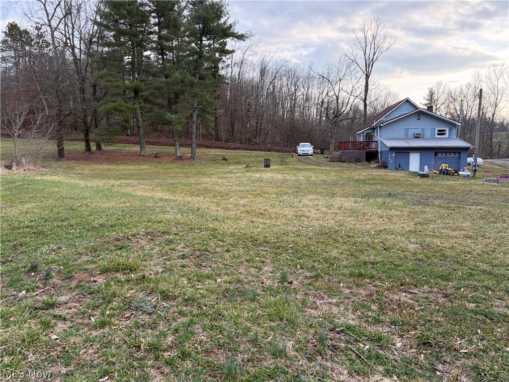 3719 Holmes Road Cambridge, OH 43725 - Photo 2 of 20 View of grassy yard featuring a wooden deck