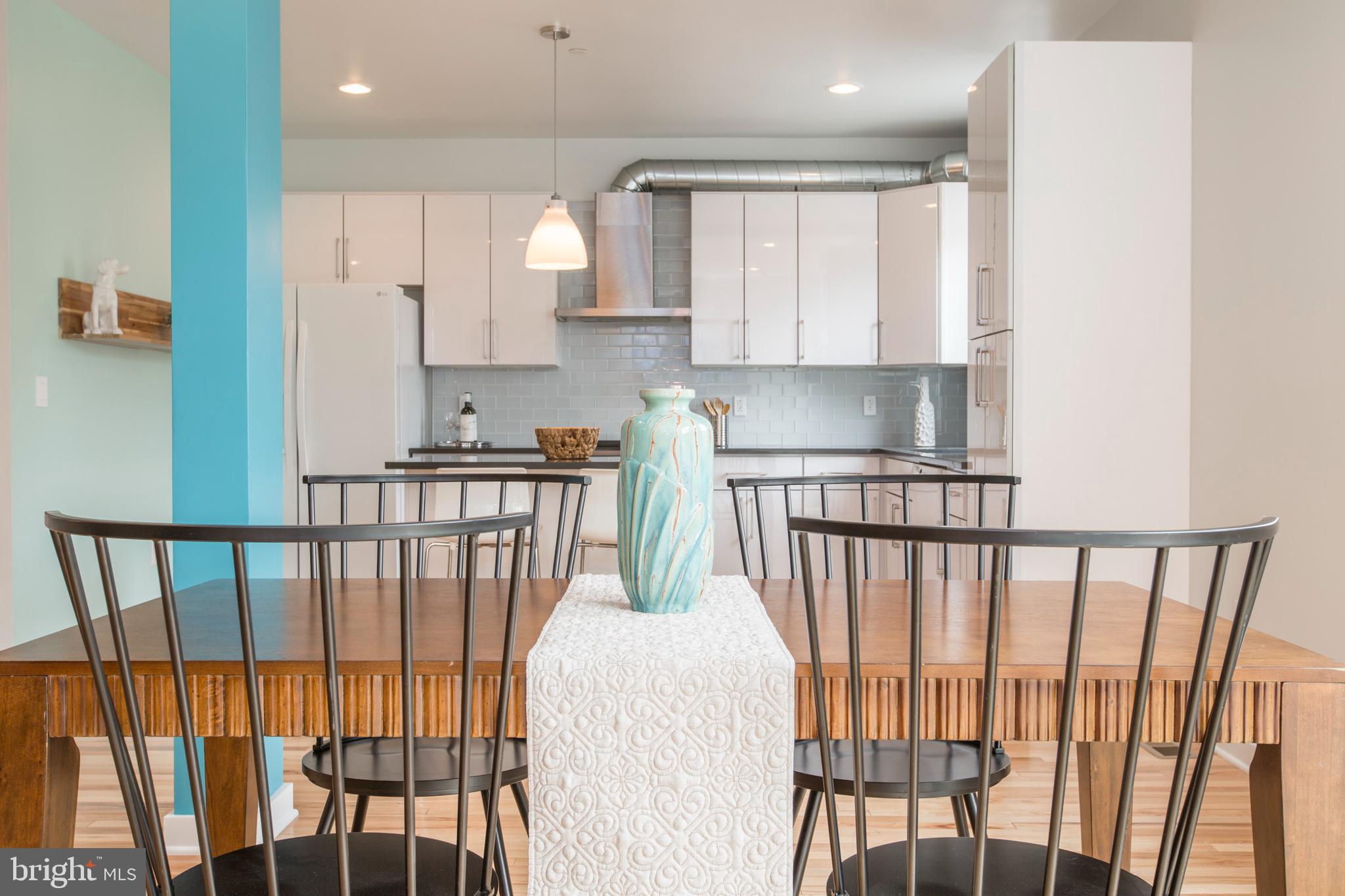 3039-41 Baltz Street Philadelphia, PA 19121 - Photo 11 of 35 a kitchen with stainless steel appliances granite countertop a refrigerator sink and white cabinets
