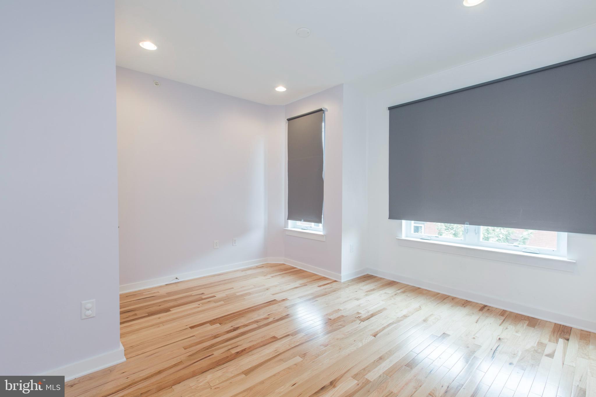 3039-41 Baltz Street Philadelphia, PA 19121 - Photo 20 of 35 a view of an empty room with wooden floor and a window
