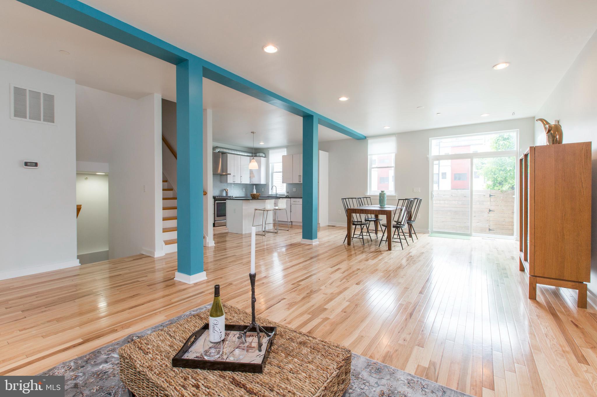 3039-41 Baltz Street Philadelphia, PA 19121 - Photo 2 of 35 a living room with furniture a wooden floor and a large window