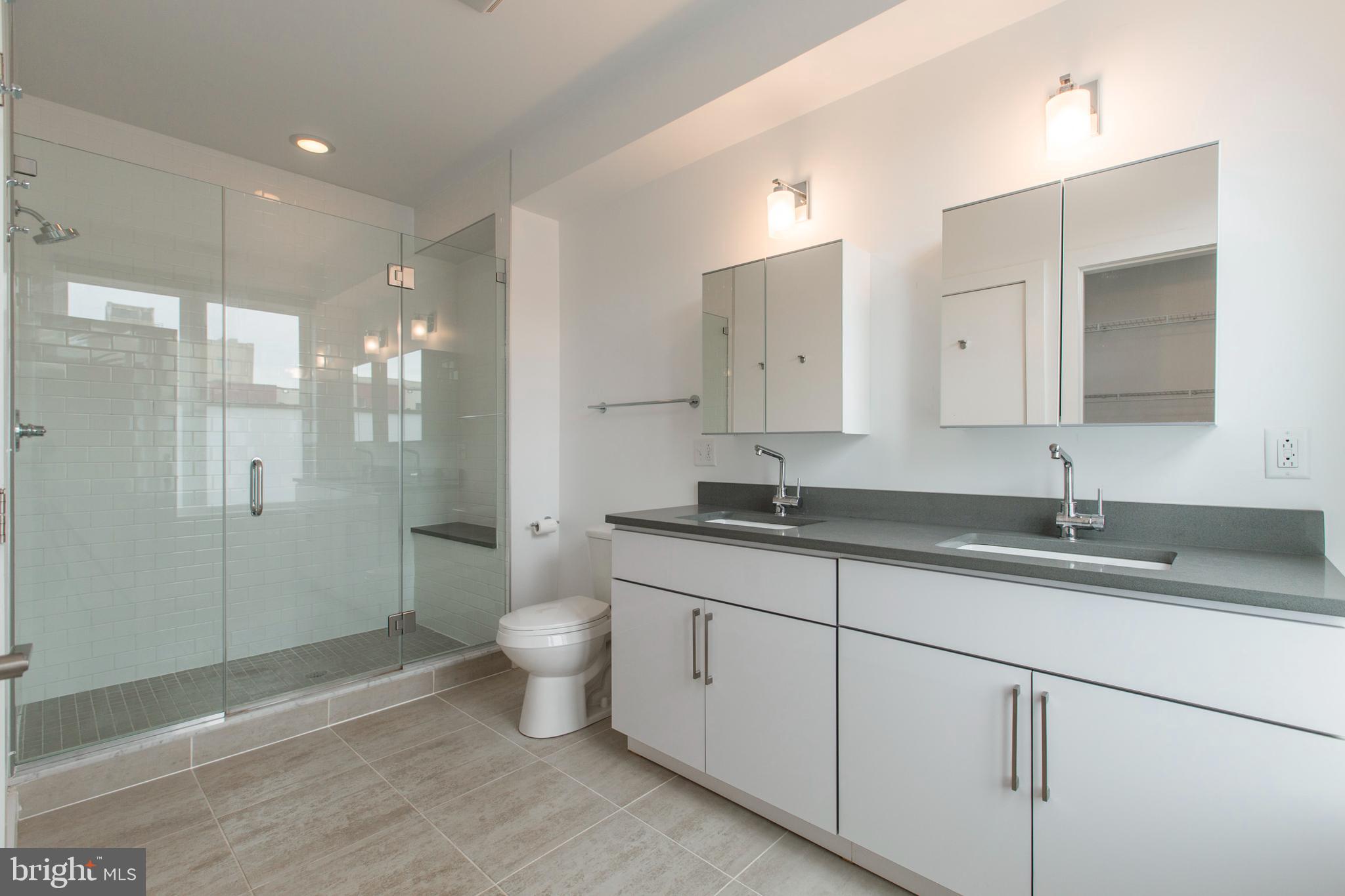 3039-41 Baltz Street Philadelphia, PA 19121 - Photo 26 of 35 a bathroom with a granite countertop sink a toilet and shower