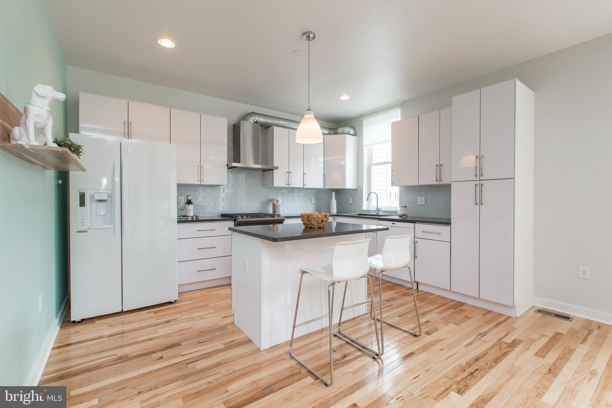 3039-41 Baltz Street Philadelphia, PA 19121 - Photo 27 of 35 a kitchen with stainless steel appliances granite countertop a refrigerator a sink dishwasher a stove a refrigerator and white cabinets with wooden floor