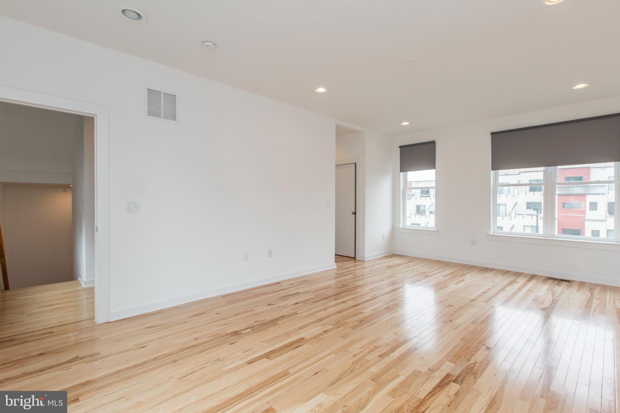 3039-41 Baltz Street Philadelphia, PA 19121 - Photo 29 of 35 a view of an empty room with wooden floor and window
